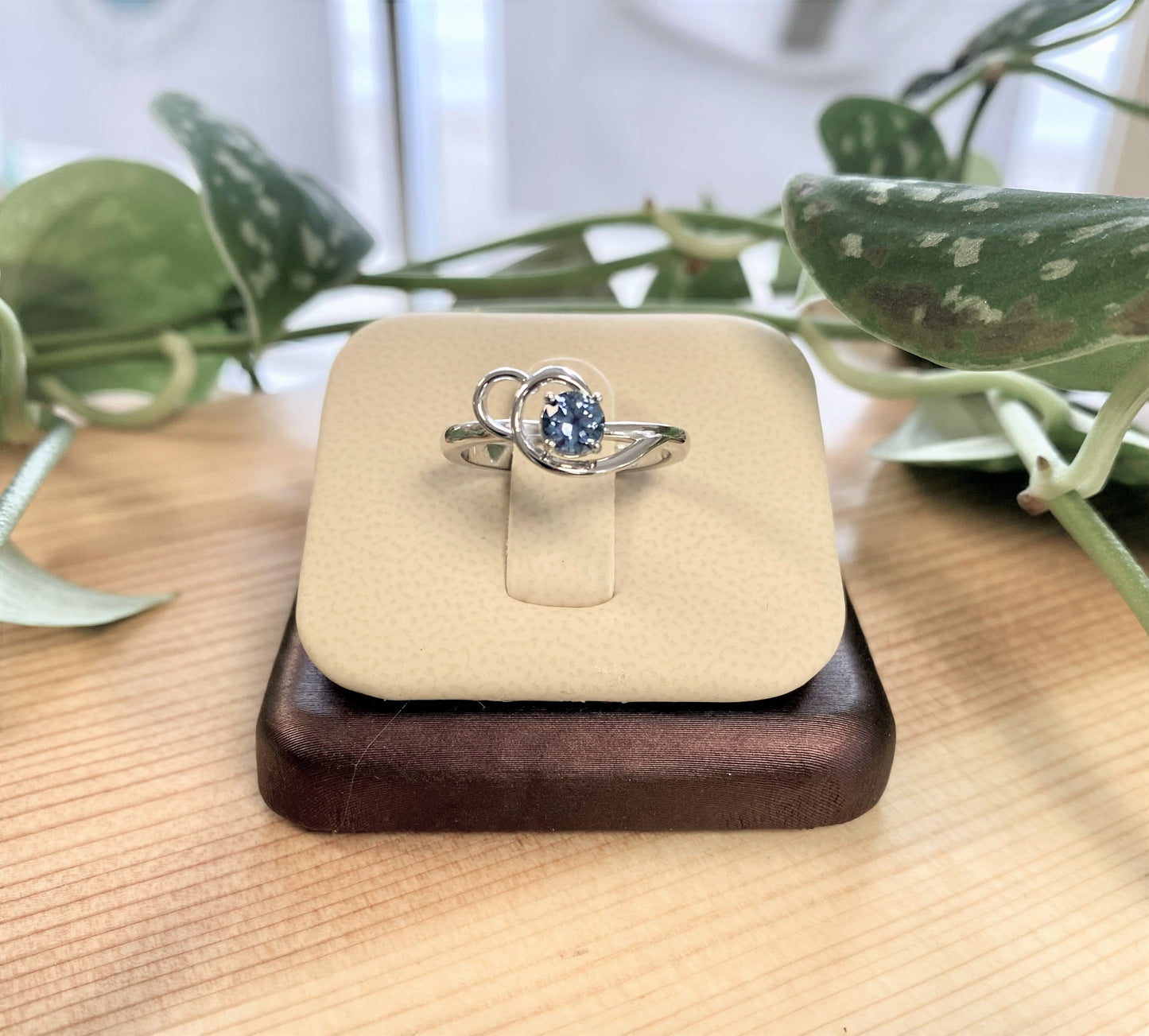 1/2 carat round Montana sapphire set in a swirl design in 14 karat white gold.